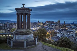 Dugald Stewart Monument and illuminated Edinburgh city viewed from Observatory House Dugald Stewart Monument and illuminated Edinburgh city viewed from Observatory House