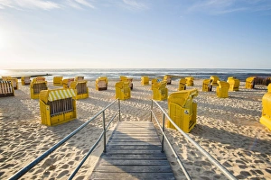 Duhnen, Cuxhaven, Lower Saxony, Germany. Yellow Strandkorbs along the beach Duhnen, Cuxhaven, Lower Saxony, Germany. Yellow Strandkorbs along the beach