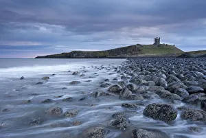 Dunstanburgh Castle above the boulder covered Embleton Bay, Northumberland, England Dunstanburgh Castle above the boulder covered Embleton Bay, Northumberland, England