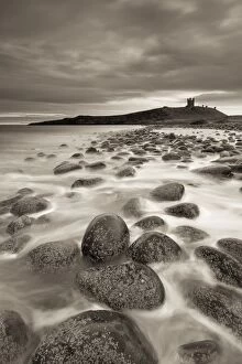 Images Dated 24th April 2013: Dunstanburgh Castle at dawn from Embleton Bay, Northumberland, England. Spring (April)
