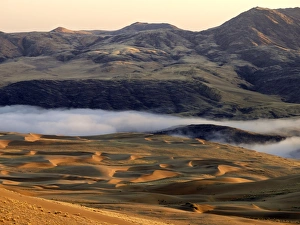 In the early morning low mist conceals the Kunene River In the early morning low mist conceals the Kunene River