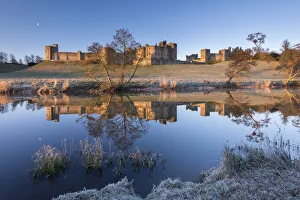 Early morning sunshine illuminates Alnwick Castle in Northumberland, England. Winter Early morning sunshine illuminates Alnwick Castle in Northumberland, England. Winter
