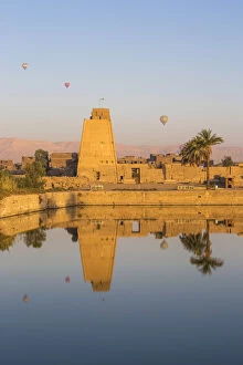 Egypt, Luxor, Karnak Temple, Hot air balloons rise over the Sacred Lake