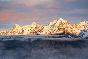 Eiger, Monch and Jungfrau mountains emerging from fog at sunset, Murren Birg, Jungfrau Region, Berner Oberland Eiger, Monch and Jungfrau mountains emerging from fog at sunset, Murren Birg, Jungfrau Region, Berner Oberland