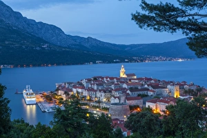 Elevated view over Korculas picturesque Stari Grad illuminated at dusk, Korcula Elevated view over Korculas picturesque Stari Grad illuminated at dusk, Korcula