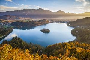Elevated view over Lake Bled & the Julian Alps illuminated at Sunrise, Lake Bled Elevated view over Lake Bled & the Julian Alps illuminated at Sunrise, Lake Bled