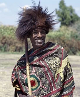 An Ethiopian man wears a headdres s made from the s kin of a gelada