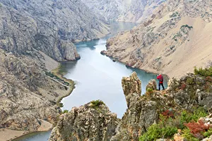Europe, Croatia, Dalmatia, Zadar region, a photographer standing over the Zrmanja Canyon Europe, Croatia, Dalmatia, Zadar region, a photographer standing over the Zrmanja Canyon