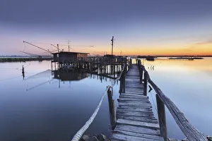 Europe, Italy, Emilia Romagna, Ferrara. Fishing huts on stilts in the valleys of Comacchio Europe, Italy, Emilia Romagna, Ferrara. Fishing huts on stilts in the valleys of Comacchio