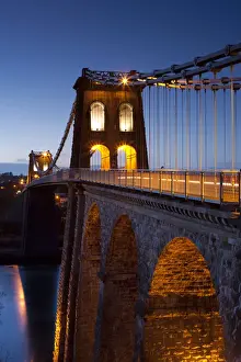 UK Suspension Bridges Prints: Evening illuminations on the Menai Bridge spanning the Menai Strait, North Wales, UK