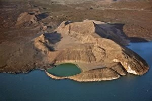 An extinct volcanic crater, Abil Agituk, at the southern end of Lake Turkana has a distinctively green crater lake