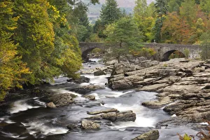 The Falls of Dochart and stone bridge surrounded by autumn foliage at Killin, Loch Lomond The Falls of Dochart and stone bridge surrounded by autumn foliage at Killin, Loch Lomond