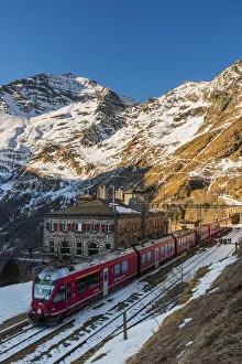 Prints of The famous Bernina Express red train at Alp Grum station, Graubunden, Switzerland Switzerland Prints: Bernina Express Red Train Print at Alp Grum Station