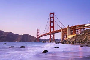 Famous Golden Gate Bridge over bay against blue sky during sunset, San Francisco Famous Golden Gate Bridge over bay against blue sky during sunset, San Francisco