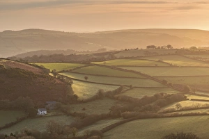 Farmhouse in idyllic rolling countryside at dawn, Dartmoor National Park, Devon, England Farmhouse in idyllic rolling countryside at dawn, Dartmoor National Park, Devon, England