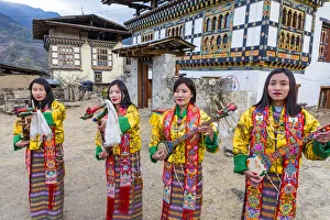 Female performers playing instruments at a local festival in Paro District, Bhutan Female performers playing instruments at a local festival in Paro District, Bhutan