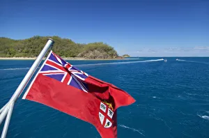 Fijian flag and Malolo Island, Mamanuca Islands, Fiji Fijian flag and Malolo Island, Mamanuca Islands, Fiji