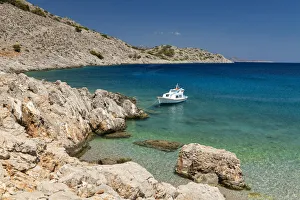 Fishing Boat in Marathounda Bay, Symi Island, Dodecanese Islands, Greece Fishing Boat in Marathounda Bay, Symi Island, Dodecanese Islands, Greece