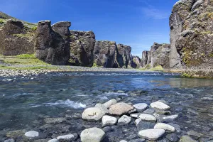 Sudurland Region Gallery: Fjadra River flowing through rocks against cliffs in Fjadrargljufur canyon on sunny day