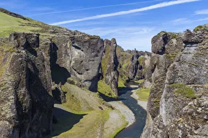 Sudurland Region Gallery: Fjadra River flowing through rocky cliffs on sunny day in Fjadrargljufur canyon, South
