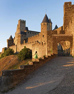 Images Dated 30th September 2013: France, Languedoc, Carcassonne, girl walking on wall to Aude gate (MR)