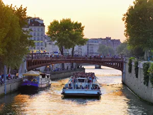 France, Paris, Tourboat on River Seine at sunset France, Paris, Tourboat on River Seine at sunset