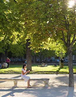 France, Provence, Nimes, Les Jardins de la Fontaine, Woman reading in park MR France, Provence, Nimes, Les Jardins de la Fontaine, Woman reading in park MR