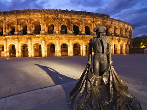France, Provence, Nimes, Roman ampitheatre, Toreador statue at dusk France, Provence, Nimes, Roman ampitheatre, Toreador statue at dusk