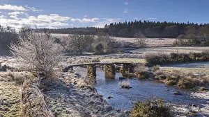 Frosty winter conditions at the old clapper bridge at Postbridge, Dartmoor, Devon Frosty winter conditions at the old clapper bridge at Postbridge, Dartmoor, Devon
