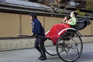 Geishas travelling in a rickshaw, Kyoto, Japan Geishas travelling in a rickshaw, Kyoto, Japan