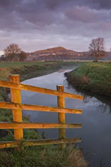 Glastonbury Tor and the River Brue at sunrise, Somerset Levels, Somerset, England. Autumn Glastonbury Tor and the River Brue at sunrise, Somerset Levels, Somerset, England. Autumn