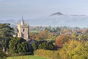 Glastonbury Tor and West Pennard Church on a misty autumn morning, Somerset, England Glastonbury Tor and West Pennard Church on a misty autumn morning, Somerset, England