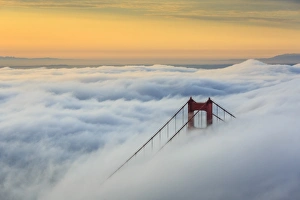 Golden Gate Bridge emerging from the morning fog at sunrise. San Francisco, Marin County Golden Gate Bridge emerging from the morning fog at sunrise. San Francisco, Marin County
