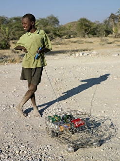 A happy youth with his ingenious homemade wire lorry A happy youth with his ingenious homemade wire lorry