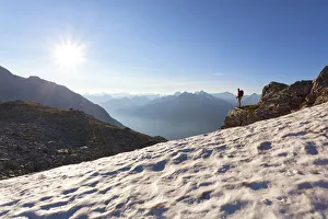 A hiker on the snowfield under the summit of Peterskopfl, Zillertal Alps A hiker on the snowfield under the summit of Peterskopfl, Zillertal Alps