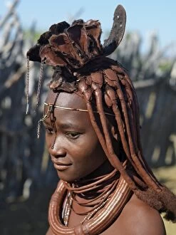 Images Dated 14th June 2006: A Himba woman in traditional attire. Her body gleams from a mixture of red ochre