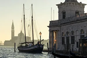 Historic trabaccolo boat at Punta della Dogana with San Giorgio Maggiore Island in the Historic trabaccolo boat at Punta della Dogana with San Giorgio Maggiore Island in the