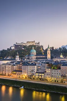 Historical old town of Salzburg reflected in Salzach river at dusk with Hohensalzburg Historical old town of Salzburg reflected in Salzach river at dusk with Hohensalzburg