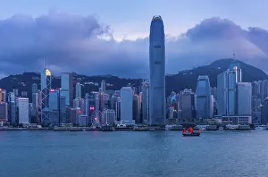 Hong Kong Island at Dusk with a Red Sailed Junk in the foreground, Hong Kong, China Hong Kong Island at Dusk with a Red Sailed Junk in the foreground, Hong Kong, China