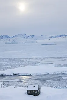 House in snow, Tiniteqilaq in winter, E. Greenland House in snow, Tiniteqilaq in winter, E. Greenland