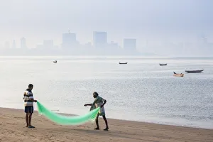 India, Maharashtra, Mumbai, Chowpatty, Men with fishing net on beach India, Maharashtra, Mumbai, Chowpatty, Men with fishing net on beach