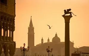 Italy, Veneto, Venice; The Palazzo dei Dogi, the bacino di San Marco with a sculpture of the lion of Venice