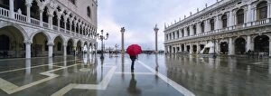 Images Dated 9th November 2014: Italy, Veneto, Venice. Woman with red umbrella in front of Doges palace with acqua alta