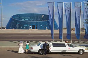Kazakhstan, Astana, Shabyt Palace of Arts, Wedding party arrive opposite Palace in Kazakhstan, Astana, Shabyt Palace of Arts, Wedding party arrive opposite Palace in