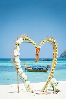 Ko Lipe, Satun Province, Thailand. Traditional long tail boats through a heart shape Ko Lipe, Satun Province, Thailand. Traditional long tail boats through a heart shape