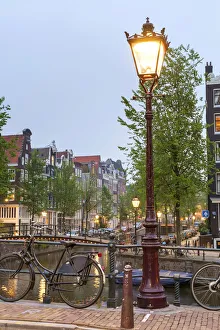 Lamp post on the Herengracht at the intersection with the Brouwersgracht at dusk Lamp post on the Herengracht at the intersection with the Brouwersgracht at dusk
