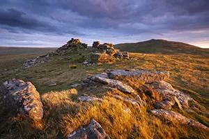 Late summer evening sunlight glowing on the granite outcrops of West Mill Tor in Dartmoor Late summer evening sunlight glowing on the granite outcrops of West Mill Tor in Dartmoor