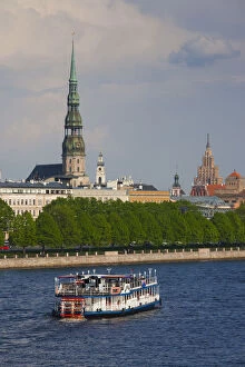Latvia, Riga, Daugava River tourist boat and Riga skyline