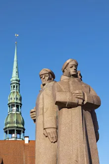 The Latvian Riflemen Monument and St. Peters Church, Old Town, Riga, Latvia The Latvian Riflemen Monument and St. Peters Church, Old Town, Riga, Latvia