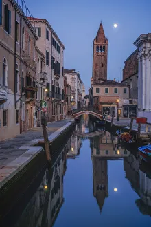 Leaning tower at dusk with moonrise in Venice, Italy Leaning tower at dusk with moonrise in Venice, Italy